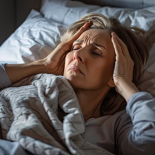 A calm adult receiving IV therapy for adrenal burnout in a comfortable wellness clinic setting.
