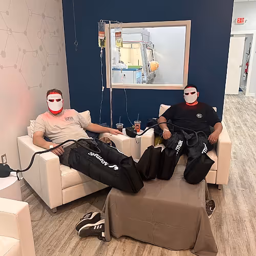 Clients relaxing comfortably during IV therapy sessions in a bright, calm wellness center.