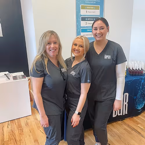Friendly staff at The DRIPBaR Hammond greeting a guest, creating a welcoming and supportive environment for wellness routines.