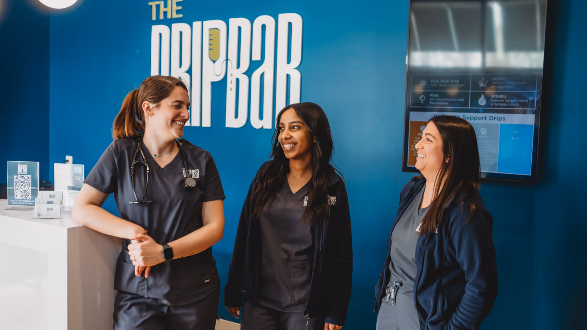 Friendly front desk staff greeting guests as they arrive at the wellness center