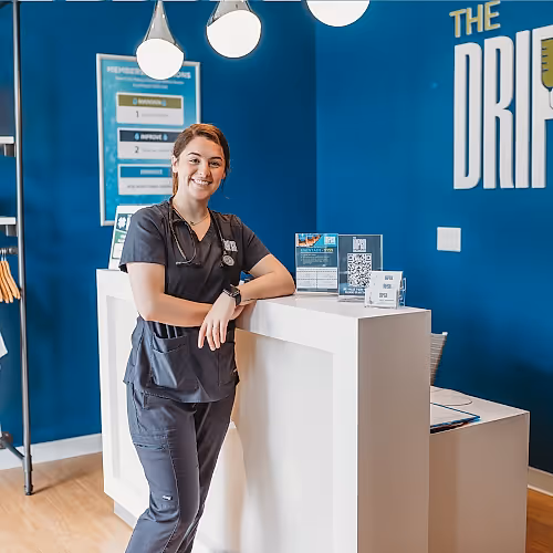 Client receiving information at the front desk of The DRIPBaR Hammond, highlighting supportive service.