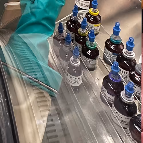 Licensed nurses preparing IV therapy treatments in a clinical setting.