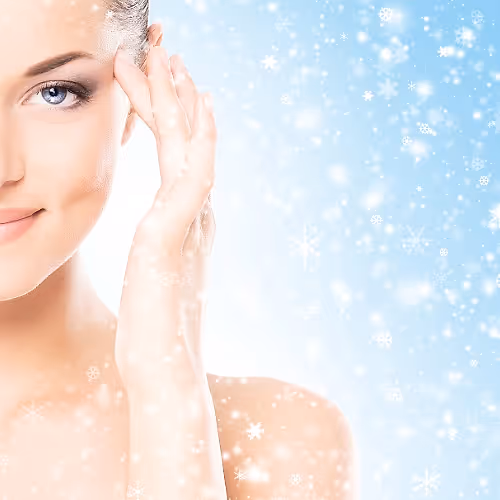 Client relaxing under a red light therapy panel, supporting skin comfort and a healthy-looking glow between facials.