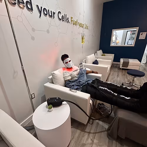 Clients relaxing comfortably in a wellness lounge during a nutrient infusion session.